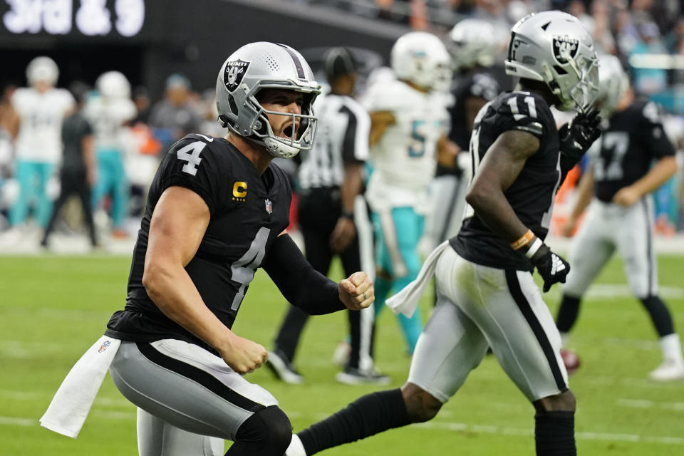 Las Vegas Raiders quarterback Derek Carr (4) celebrates after wide receiver Hunter Renfrow scored a touchdown against the Miami Dolphins during the second half of an NFL football game, Sunday, Sept. 26, 2021, in Las Vegas. (AP Photo/Rick Scuteri)