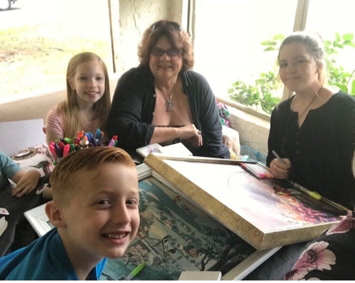 Joan Crutcher of  West Melbourne is pictured with young relatives at a family Thanksgiving dinner at her sister Bonnie's house in Winter Garden. An artist, Crutcher comes up with crafts projects for the Turkey Day gatherings.