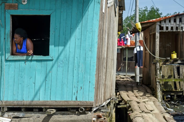 In the Ciudad 2000 neighborhood, shacks are built over the fetid waters of a swamp and connected by a tangled web of rickety wooden bridge