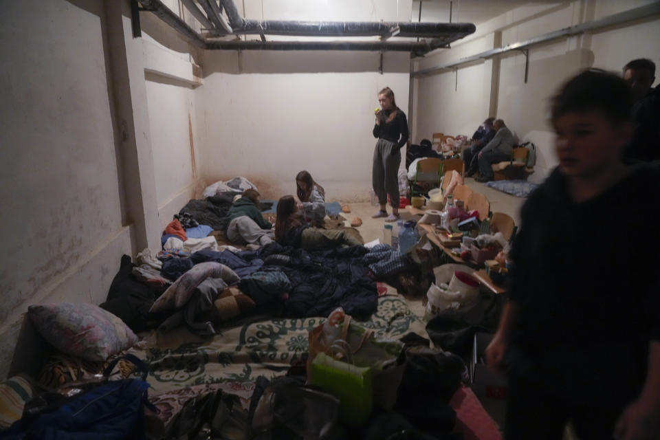 FILE - People shelter from Russian artillery shelling in a school basement in the village of Horenka close to Kyiv, Ukraine, Sunday, March 6, 2022. (AP Photo/Efrem Lukatsky, File)