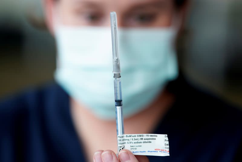 FILE PHOTO: The Pfizer COVID-19 vaccine is prepared by a healthcare worker in Melbourne