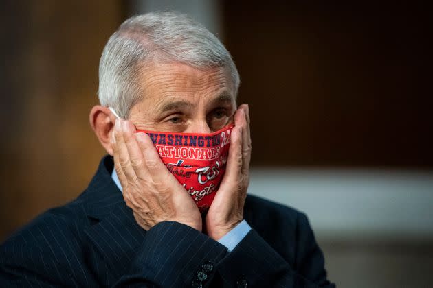 Dr Anthony Fauci, director of the National Institute of Allergy and Infectious Diseases, adjusts his face mask as he arrives for a Senate hearing in June. He and other public health experts say masks help slow the spread of the coronavirus, but President Donald Trump has often mocked mask-wearing and has refused to back a national mask mandate.