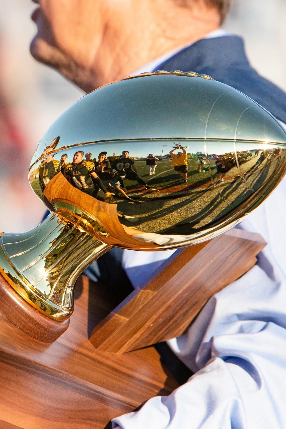 November 27, 2021; Gilbert, AZ; Trophy reflects the Arizona Lutheran Footbal players celebrating victory after the 2a football championship game against Morenci