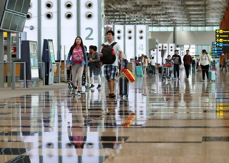 Travellers seen at Changi Airport’s Terminal 3. (PHOTO: Reuters)