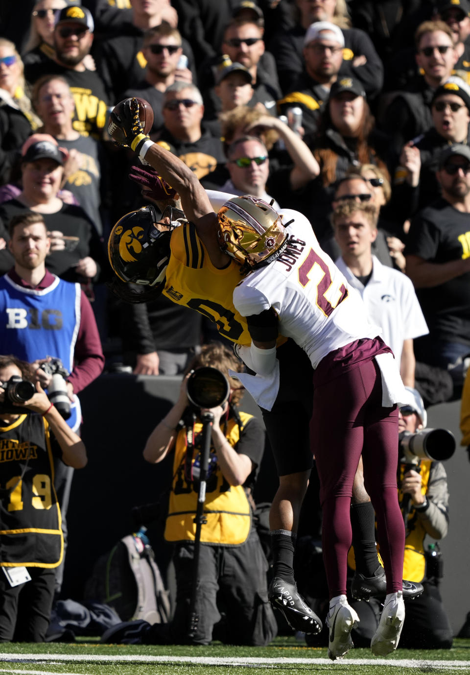 Iowa wide receiver Diante Vines (0) pulls in a reception for a first down in front of Minnesota defensive back Tre'Von Jones (2) during the first half of an NCAA college football game, Saturday, Oct. 21, 2023, in Iowa City, Iowa. (AP Photo/Matthew Putney)