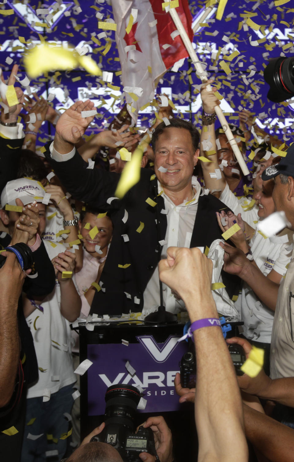 Juan Carlos Varela, Panama's president elect, waves to supporters after delivering his acceptance speech in Panama City, Sunday, May 4, 2014. Varela was declared the victor of Panama's presidential election, thwarting an attempt by former ally President Ricardo Martinelli to extend his grip on power by electing a hand-picked successor. (AP Photo/Arnulfo Franco)