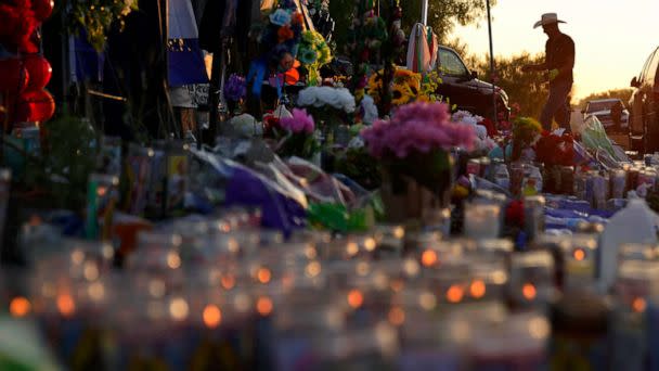 PHOTO: Roberto Marquez adds crosses to a makeshift memorial at the site where officials more than 50 people dead in an abandoned semitrailer containing suspected migrants, June 30, 2022, in San Antonio. (Eric Gay/AP)