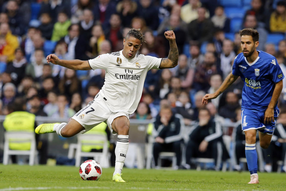 Real Madrid's Mariano Diaz, left, lines up a shot on goal during a round of 32, 2nd leg, Spanish Copa del Rey soccer match between Real Madrid and Melilla at the Santiago Bernabeu stadium in Madrid, Spain, Thursday, Dec. 6, 2018. (AP Photo/Paul White)