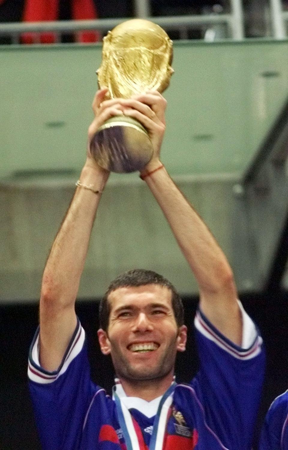 FILE - French striker Zinedine Zidane holds up the World Cup trophy after France defeated Brazil 3-0 during the final of the soccer World Cup 98 at the Stade de France in Paris on Sunday, July 12, 1998. (AP Photo/Michel Euler, File)