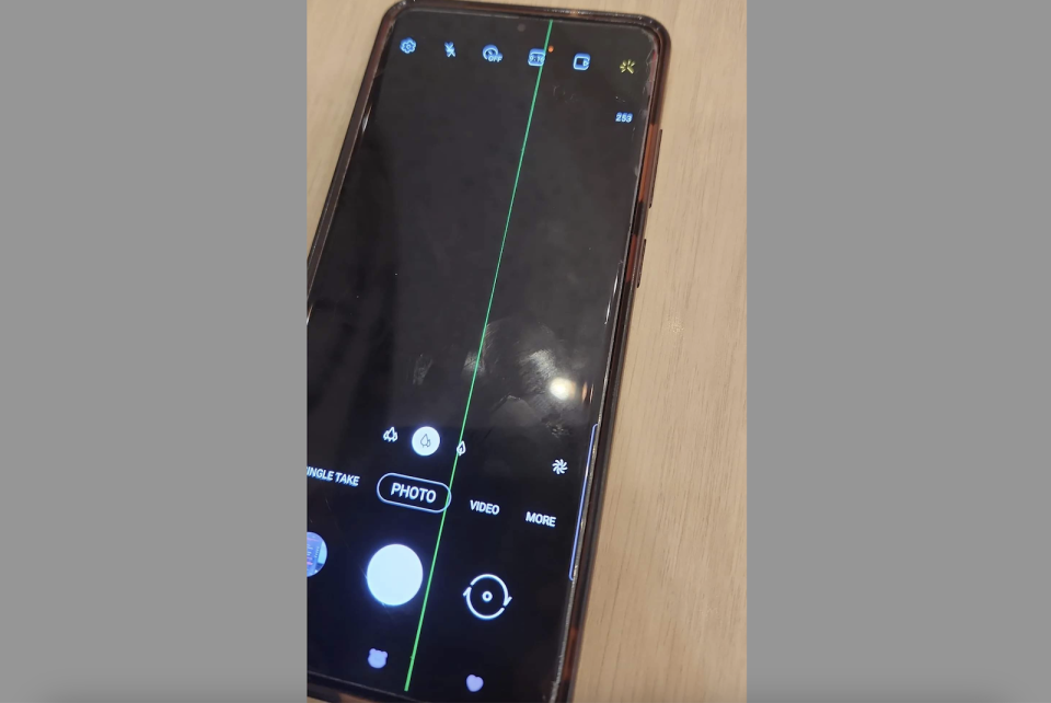 A Samsung Galaxy S20+ with a green line defect on its screen