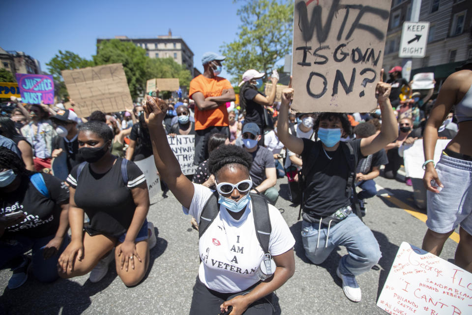 Protesters take a knee while marching through Harlem during a solidarity rally for George Floyd, Saturday, May 30, 2020, in New York. Floyd died after Minneapolis police officer Derek Chauvin pressed his knee into his neck for several minutes even after he stopped moving and pleading for air. (AP Photo/Mary Altaffer)