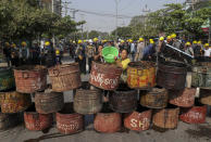 People build barricades to deter security personnel from entering a protest area in Mandalay, Myanmar, Thursday, March 4, 2021. Demonstrators in Myanmar protesting last month's military coup returned to the streets Thursday, undaunted by the killing of at least 38 people the previous day by security forces. (AP Photo)