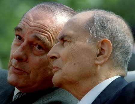 FILE PHOTO: File photo of Newly elected French President Jacques Chirac listens to outgoing French President Francois Mitterrand during a ceremony in Paris