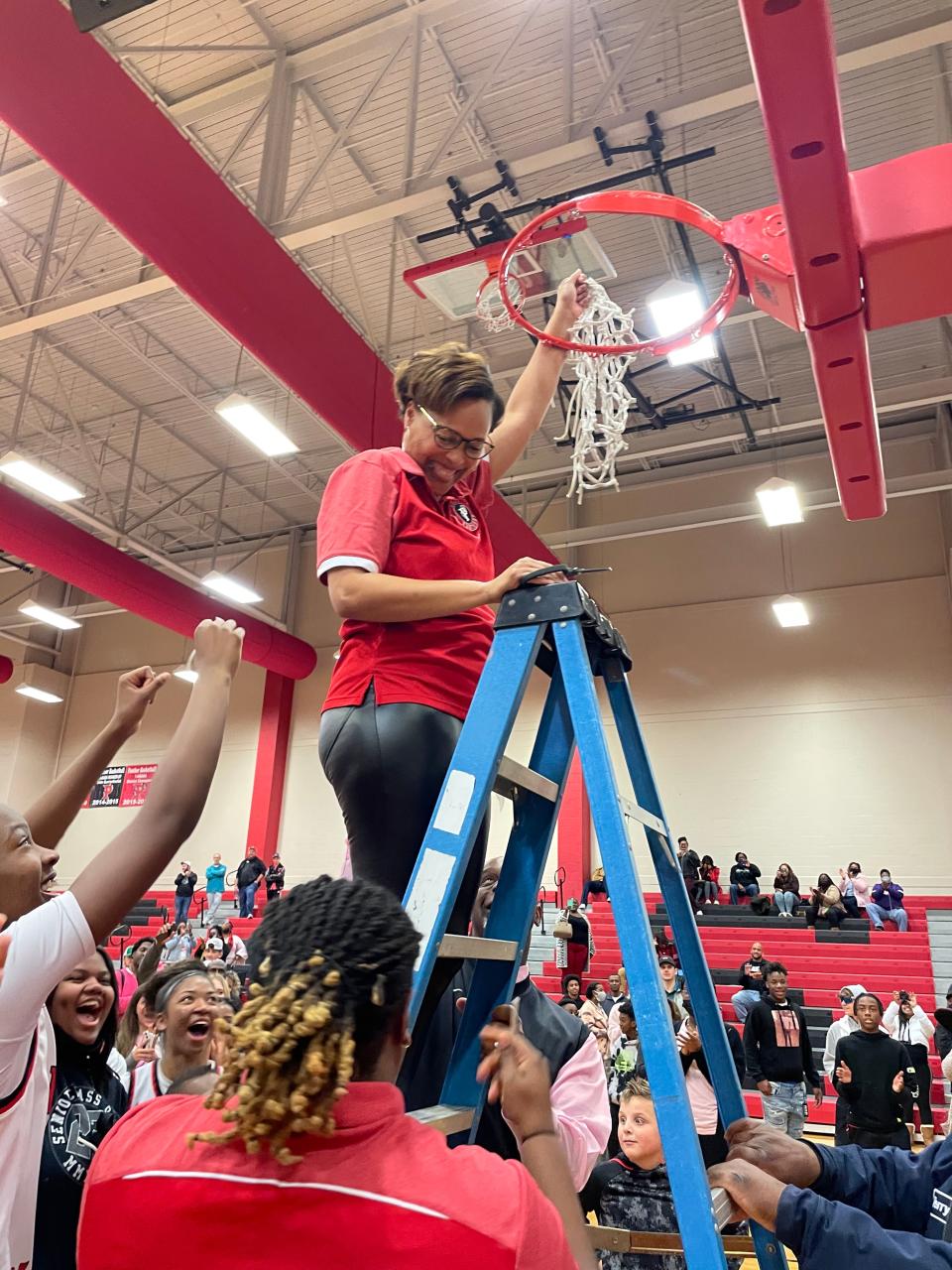 Parkway coach Gloria Williams is all smiles while cutting down the nets after her team advanced to the LHSAA Class 5A Final Four next week in Hammond.