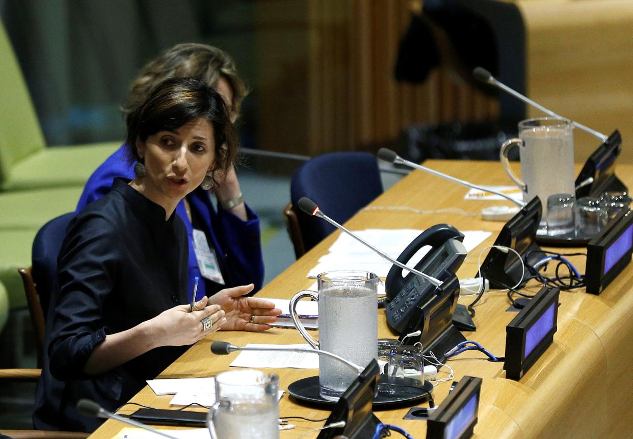 Francesca Albanese sits at a desk during a forum.