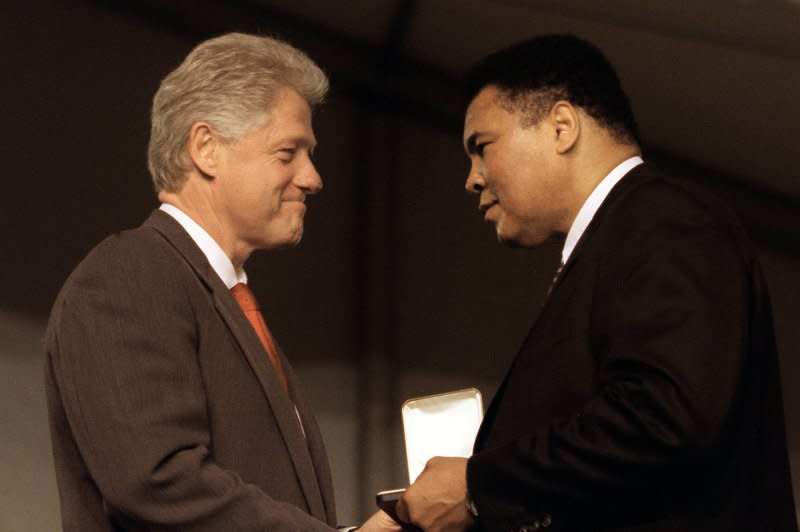 President Bill Clinton (L) presents Muhammad Ali a Presidential Citizen's Medal at a White House ceremony in 2002. File Photo by UPI