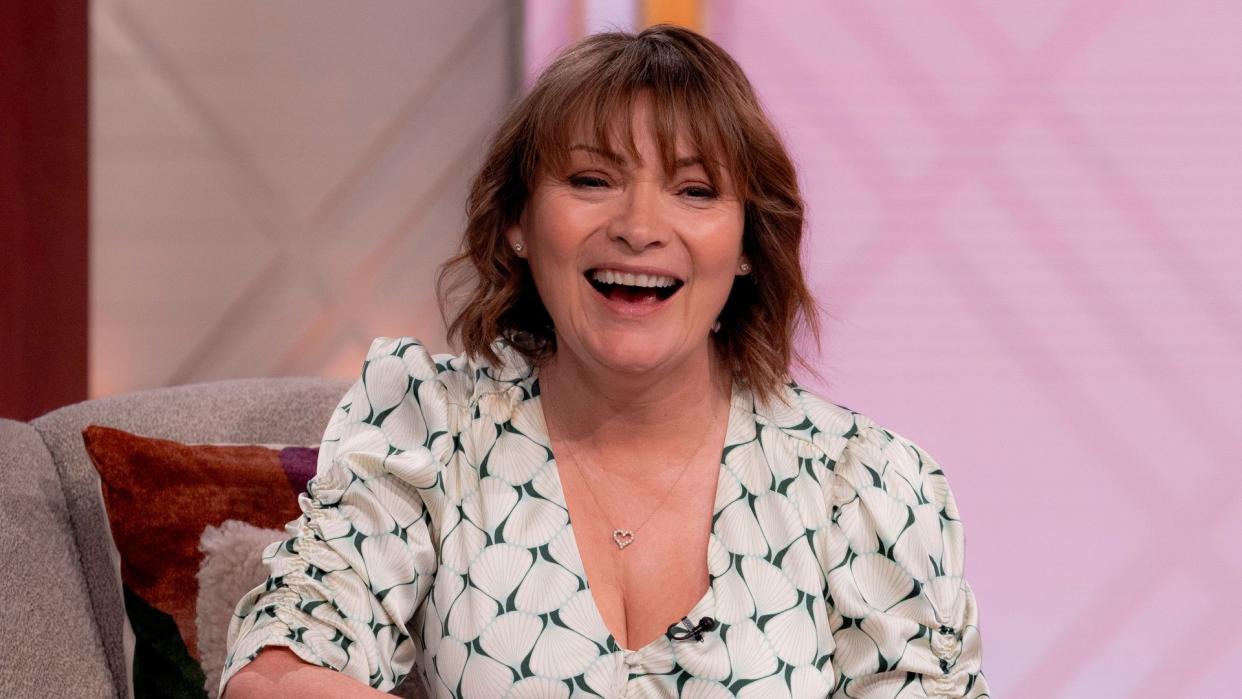 Lorraine Kelly laughing in a white dress