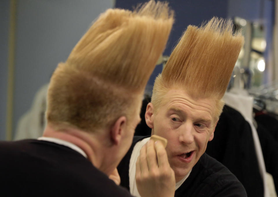 This March 23, 2013 photo shows performer Bello Nock appling make-up in his dressing room as he prepares for his "Bello Mania" show at the New Victory Theater in New York. Nock, a seventh-generation circus performer, is never offstage during the 90-minute performance, which combines slapstick clowning with death-defying aerial stunts. He performs through March 31 at the New Victory before moving on to the Canadian side of Niagara Falls and then a 10-week stint at the Beau Rivage Casino in Biloxi, Miss. (AP Photo/Richard Drew)