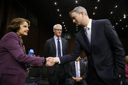 Sean Edgett, acting general counsel for Twitter, is greeted by Senator Dianne Feinstein (D-CA); as Colin Stretch, general counsel for Facebook, arrives prior to testifying before a Senate Judiciary Crime and Terrorism Subcommittee hearing on on "ways to combat and reduce the amount of Russian propaganda and extremist content online," on Capitol Hill in Washington, U.S., October 31, 2017. REUTERS/Jonathan Ernst