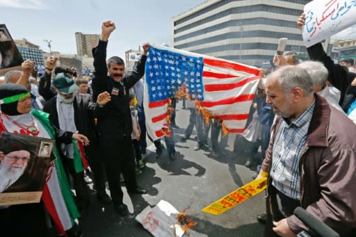 Iranian demonstrators burn a makeshift US flag during a rally in the capital Tehran