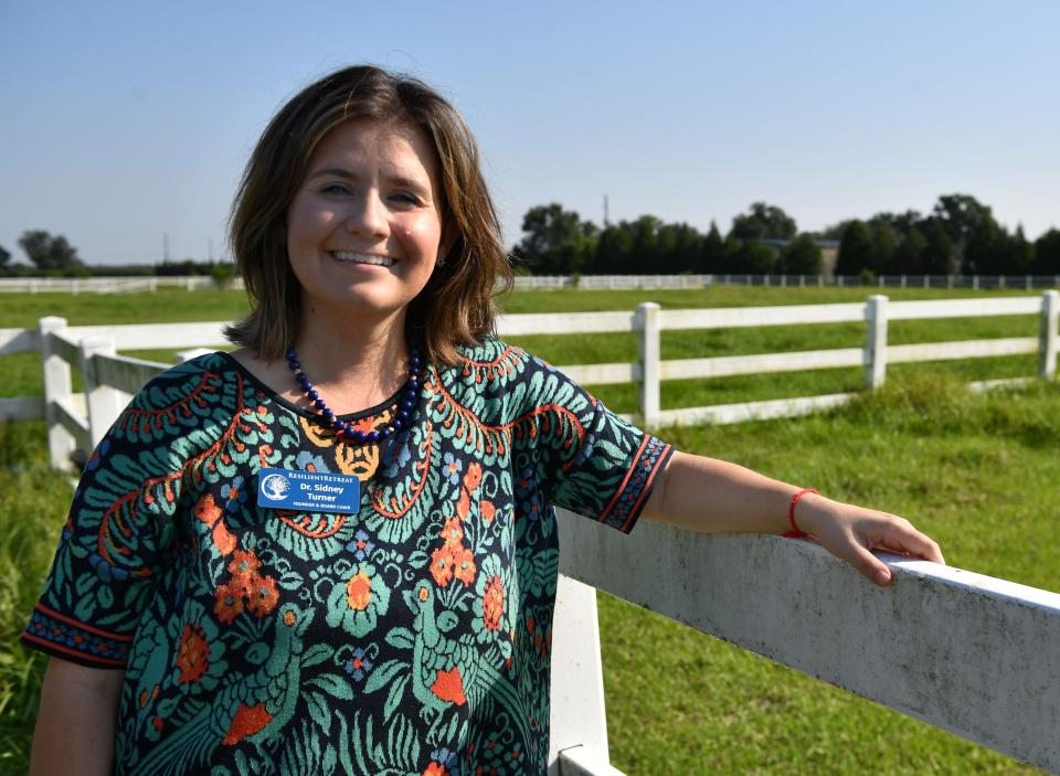 Sidney Turner is founder and chair of the board of directors at Resilient Retreat.  She stands next to one of the pastures where they plan to offer equine therapy programs. Resilient Retreat will provide free evidence-based programs for those impacted by trauma and abuse. 