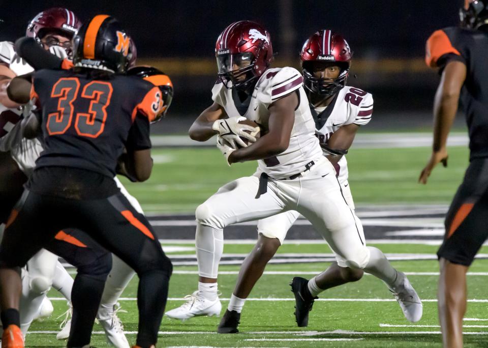 Peoria High's Maliek Ross takes a handoff from quarterback Breon Green as the Lions battle Manual in the first half of their varsity football game Friday, Sept. 22, 2023 at Peoria Stadium. The Lions defeated their rival Rams 58-0.