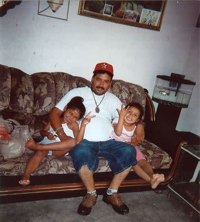 Guillermo Arevalo Pedraza (C) sits with his daughters in an undated photo released by his family in Nuevo Laredo, Mexico. REUTERS/Family of Guillermo Arevalo Pedraza/Handout via Reuters