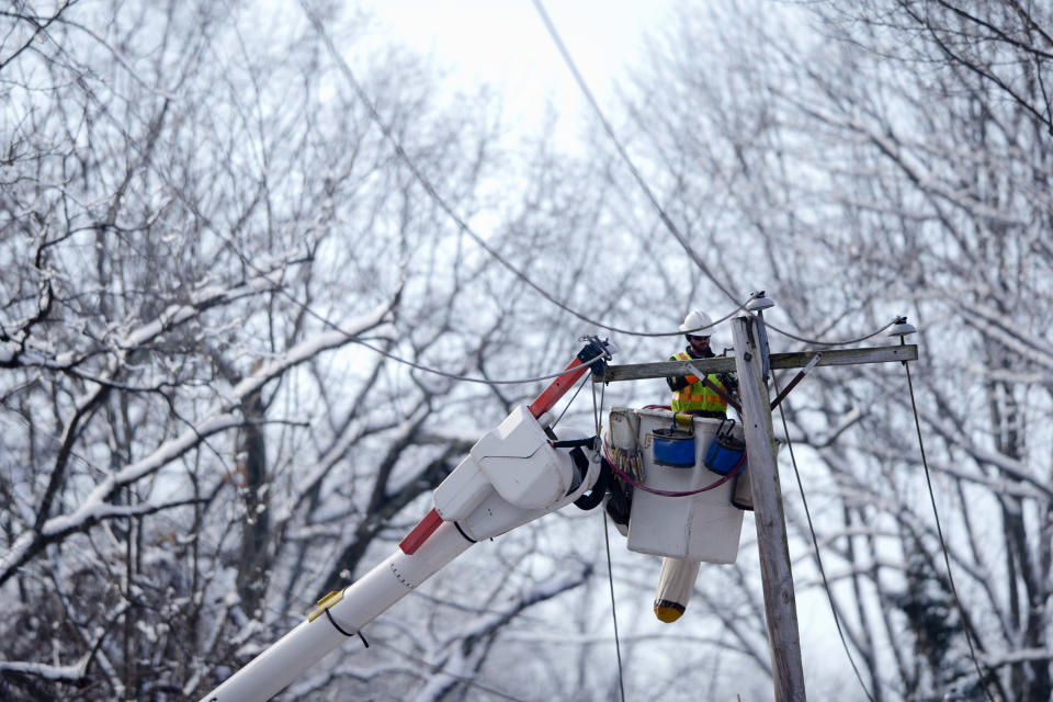 A linesman works to restore electrical power, Friday, Feb. 7, 2014, in Downingtown, Pa. A small army of electricity restoration crews labored Friday to reconnect about 330,000 customers in Pennsylvania and Maryland. (AP Photo/Matt Rourke)