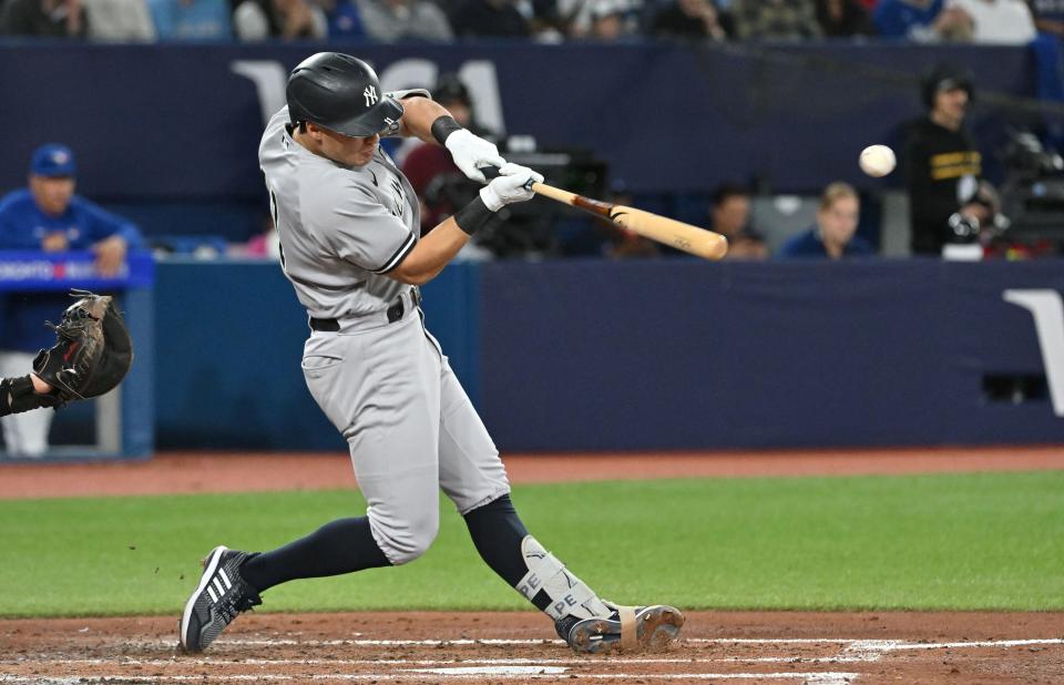 Sep 27, 2023; Toronto, Ontario, CAN; New York Yankees shortstop Anthony Volpe (11) hits a single against the Toronto Blue Jays in the fourth inning at Rogers Centre. Mandatory Credit: Dan Hamilton-USA TODAY Sports