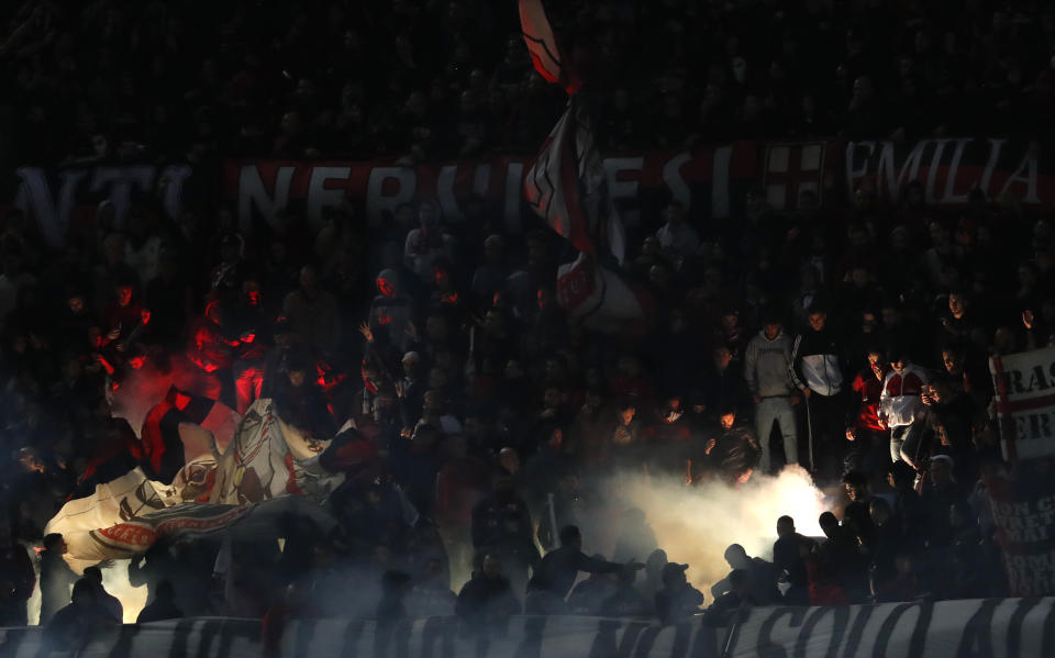 AC Milan's supporters burn flares during the Serie A soccer match between Inter Milan and AC Milan at the San Siro Stadium, in Milan, Italy, Sunday, Oct. 21, 2018. (AP Photo/Antonio Calanni)