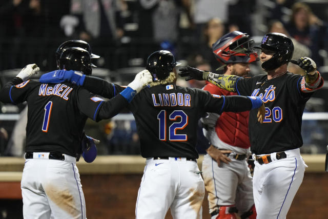 New York Mets' Pete Alonso (20) celebrates with teammates Francisco Lindor (12), Jeff McNeil (1) and Brandon Nimmo, back left, after hitting a grand slam as Cleveland Guardians catcher Cam Gallagher, back right, stands nearby during the seventh inning of a baseball game Friday, May 19, 2023, in New York. (AP Photo/Frank Franklin II)