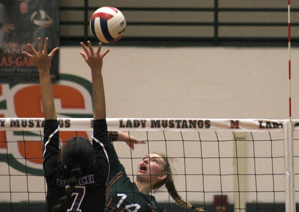 Mandarin's Macy DuBois (14) rises to spike the ball as Fletcher's Miller Grandy (7) defends  during the Gateway Conference high school volleyball championship game on October 13, 2022. [Clayton Freeman/Florida Times-Union]