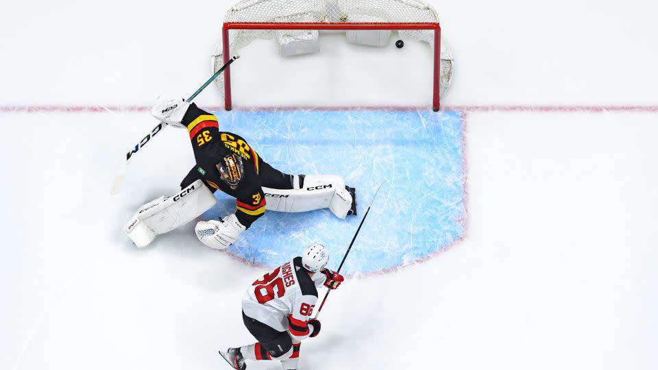 Jack Hughes scores past Canucks goalie Thatcher Demko in the first period. - Derek Cain/Getty Images