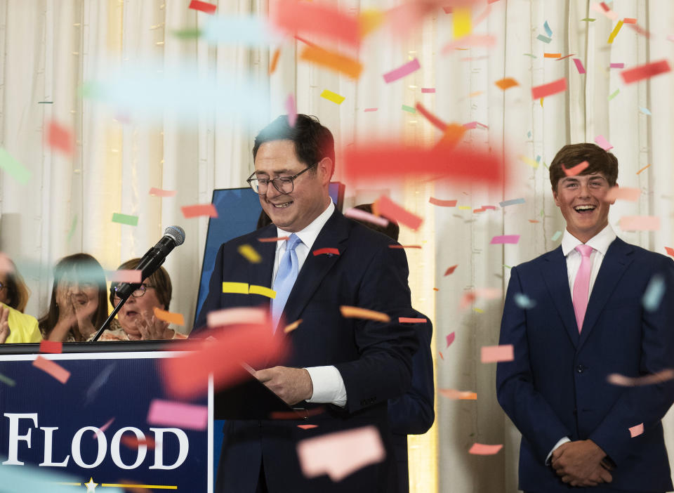 Confetti falls around Mike Flood and oldest son Brenden at an election night party on Tuesday, June 28, 2022, at Midtown Event Center in Norfolk, Neb. Nebraska state Sen. Mike Flood won a special election Tuesday to replace former U.S. Rep. Jeff Fortenberry, a fellow Republican who was sentenced to two years of probation earlier in the day for a conviction on charges that he lied to federal agents.(Gwyneth Roberts/Lincoln Journal Star via AP)