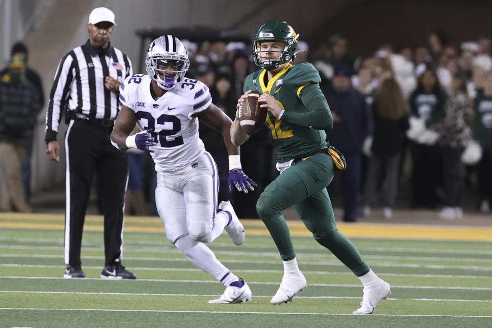 Baylor quarterback Blake Shapen (12) runs by Kansas State linebacker Desmond Purnell (32) in the first half of an NCAA college football game, Saturday, Nov. 12, 2022, in Waco, Texas. (AP Photo/Jerry Larson)