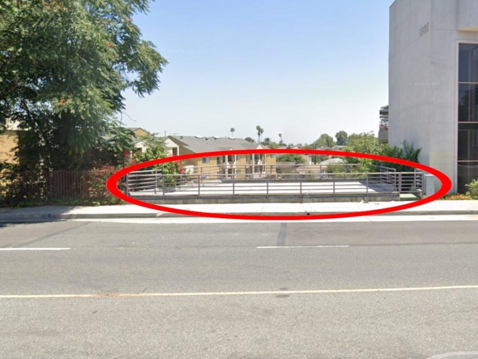 The house is located underneath the street. Only the railings on the roof,  circled in red, can be seen from street level.