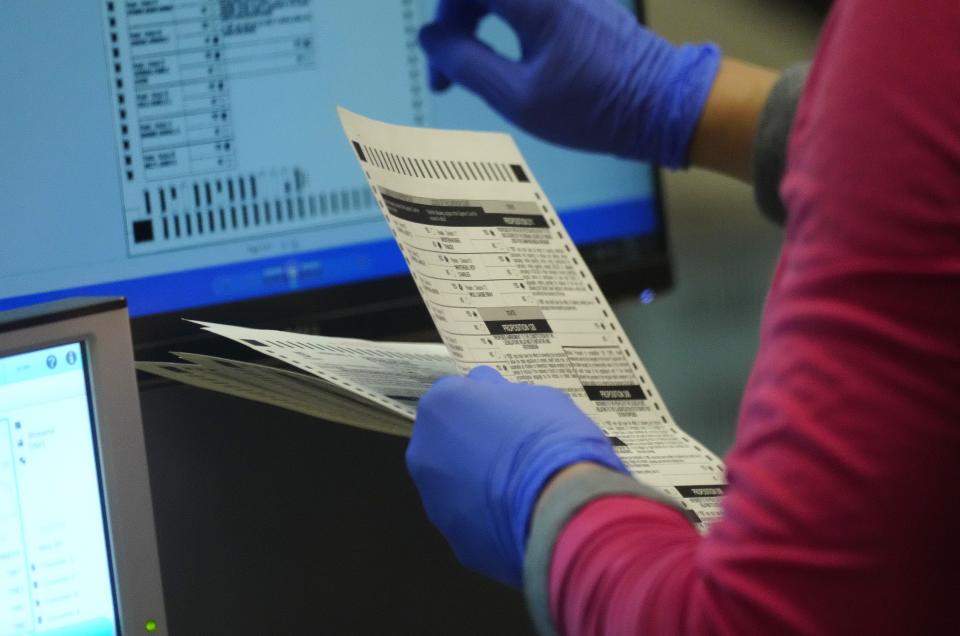 Ballots are run at Maricopa County Tabulation and Election Center (MCTEC) on Nov. 9 in Phoenix, Ariz.