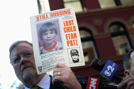 New York Police Department spokesman Paul Brown holds an original missing poster of Etan Patz during a news conference near a New York City apartment building, where police and FBI agents were searching a basement for clues in the boy's 1979 disappearance, in New York April 19, 2012. REUTERS/Keith Bedford