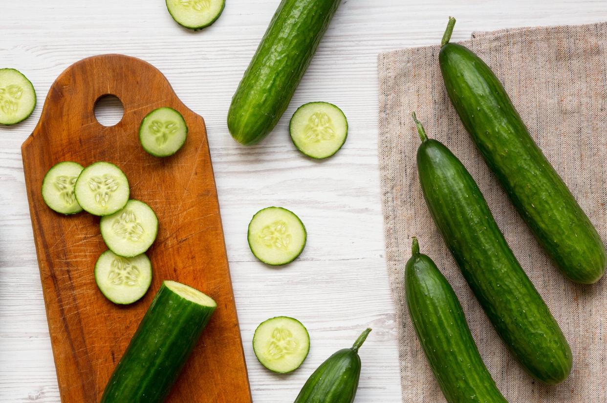 Cucumbers and cutting board on table