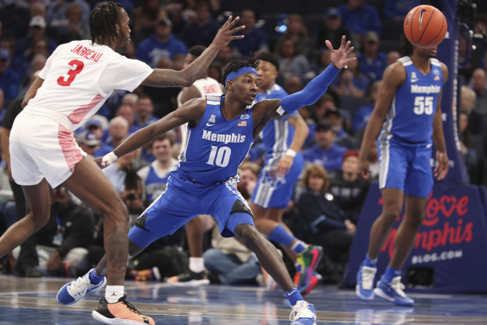 Memphis guard Damion Baugh (10) and Houston guard Dejon Jarreau (3) go for a loose ball in the second half of an NCAA college basketball game Saturday, Feb. 22, 2020, in Memphis, Tenn. (AP Photo/Karen Pulfer Focht)