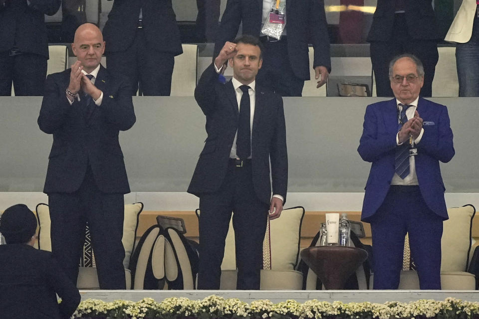 FIFA President Gianni Infantino, left, and French President Emmanuel Macron, center, arrive for the World Cup semifinal soccer match between France and Morocco at the Al Bayt Stadium in Al Khor, Qatar, Wednesday, Dec. 14, 2022. (AP Photo/Martin Meissner)