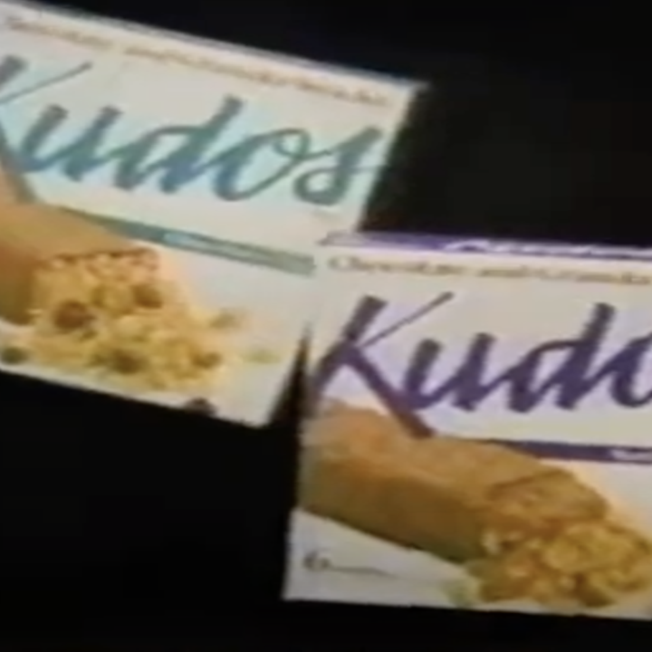 Three varieties of Kudos bar retail boxes from an 80s TV ad
