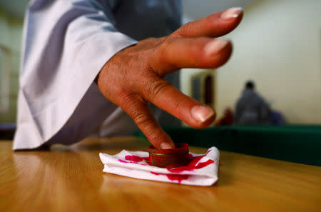 A man has his finger stained with ink during the second day of the referendum on draft constitutional amendments, at a polling station in Cairo, Egypt April 21, 2019. REUTERS/Amr Abdallah Dalsh