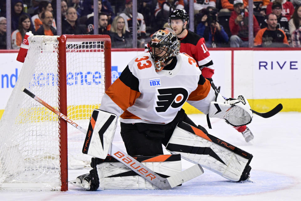 Philadelphia Flyers goaltender Samuel Ersson (33) looks for the puck during the first period of an NHL hockey game against the New Jersey Devils, Saturday, April 13, 2024, in Philadelphia. (AP Photo/Derik Hamilton)