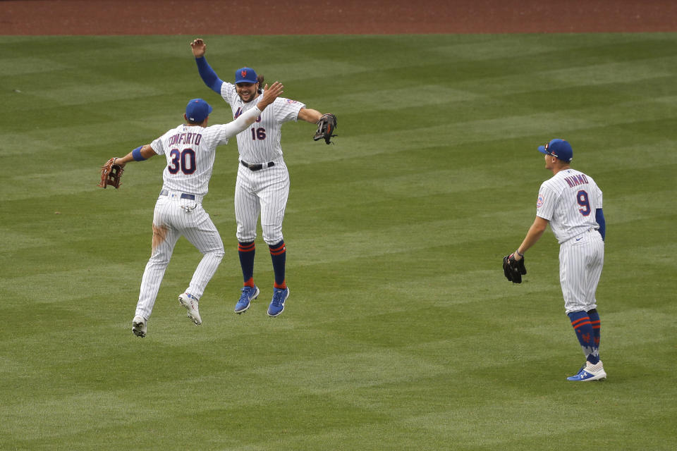 New York Mets outfielders Michael Conforto, left, Jake Marisnick, center, and Brandon Nimmo react after a baseball game against the Atlanta Braves at Citi Field, Friday, July 24, 2020, in New York. (AP Photo/Seth Wenig)