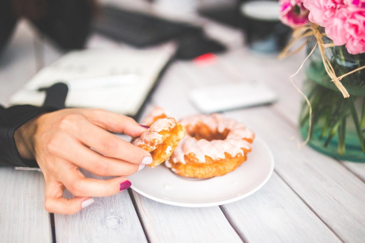 A new study has revealed women are consuming 100,000 extra calories by snacking at their desk [Photo: Kaboompics // Karolina via Pexels Oluwaseun Duncan via Pexels]