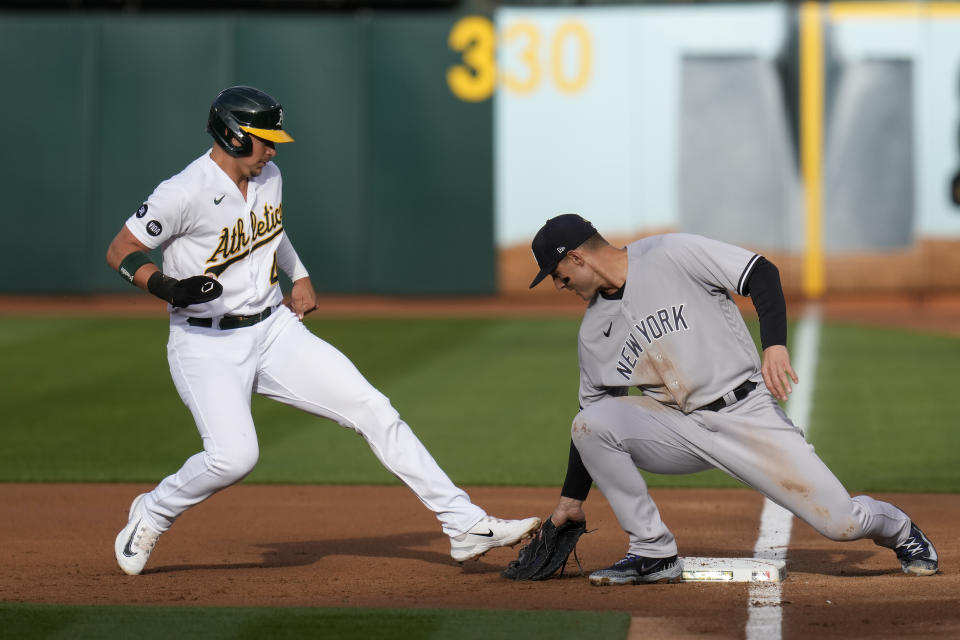 New York Yankees first baseman Anthony Rizzo, right, tags out Oakland Athletics' Ryan Noda at first on a pickoff throw from catcher Jose Trevino during the first inning of a baseball game in Oakland, Calif., Tuesday, June 27, 2023. (AP Photo/Godofredo A. Vásquez)