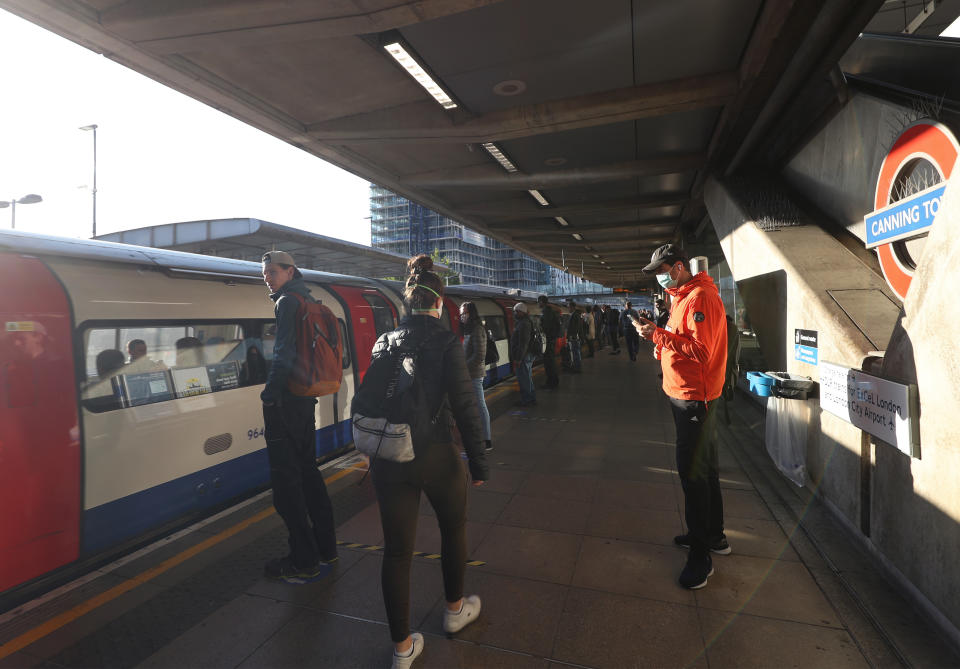 Commuters at Canning Town underground station in east London, after the introduction of measures to bring the country out of lockdown. (Photo by Yui Mok/PA Images via Getty Images)