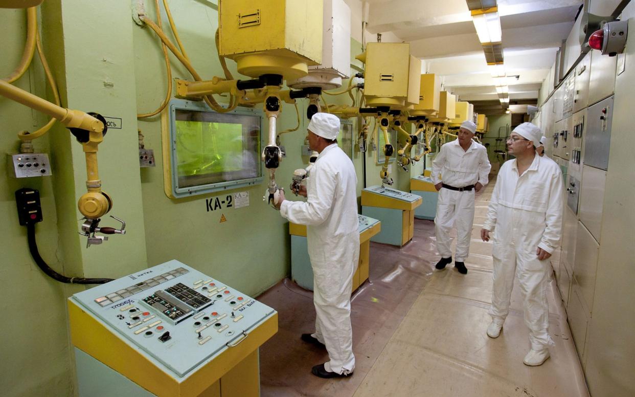 An employee works with plutonium at the Mayak nuclear processing facility in the Urals. Russia has registered high levels of ruthenium-106 in a nearby village.  - www.alamy.com