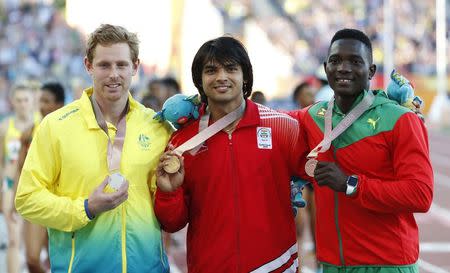 Athletics - Gold Coast 2018 Commonwealth Games - Men's Javelin Throw - Medal Ceremony - Carrara Stadium - Gold Coast, Australia - April 14, 2018. Gold medalist Neeraj Chopra of India, silver medalist Hamish Peacock of Australia and bronze medalist Anderson Peters of Grenada on the podium. REUTERS/Paul Childs